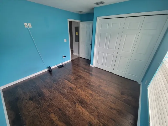 a view of a room with wooden floor