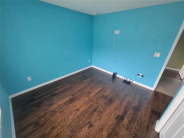 a view of a room with wooden floor