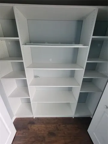 a view of walk in closet with empty racks