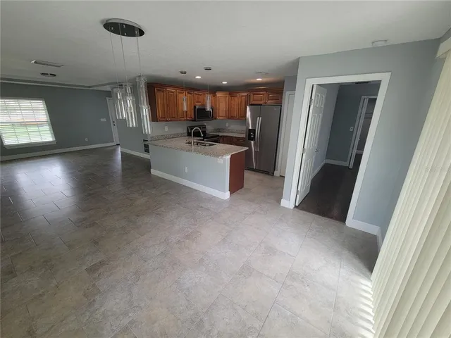 a view of a kitchen with a sink and a refrigerator