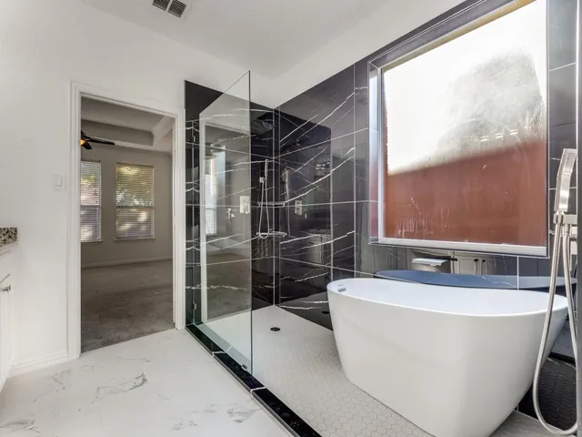 a bathroom with a bathtub and shower