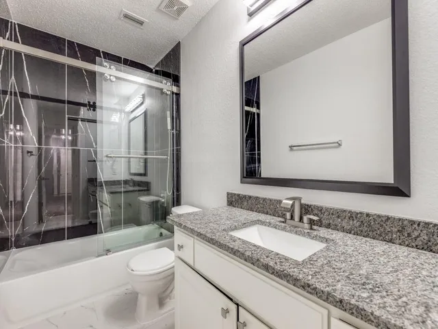 a view of a backyard with a garden and entertaining space