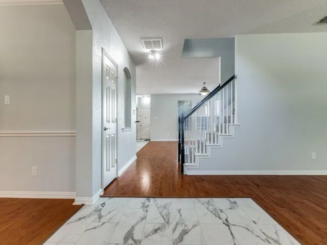 a view of entryway and hall with wooden floor