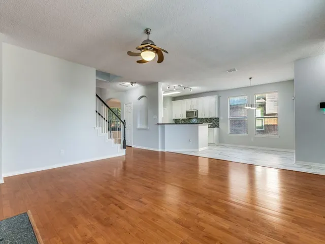 a view of a kitchen with a dishwasher and wooden floor