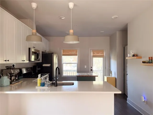 a view of a kitchen and dining area with a large window