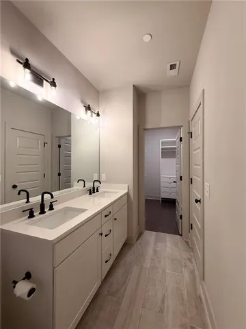 a bathroom with a double vanity sink and mirror