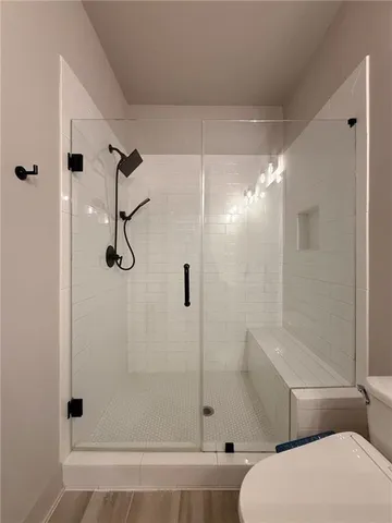 a bathroom with a toilet and a shower