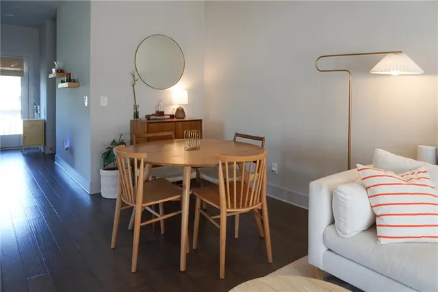 a dining room with furniture and a mirror