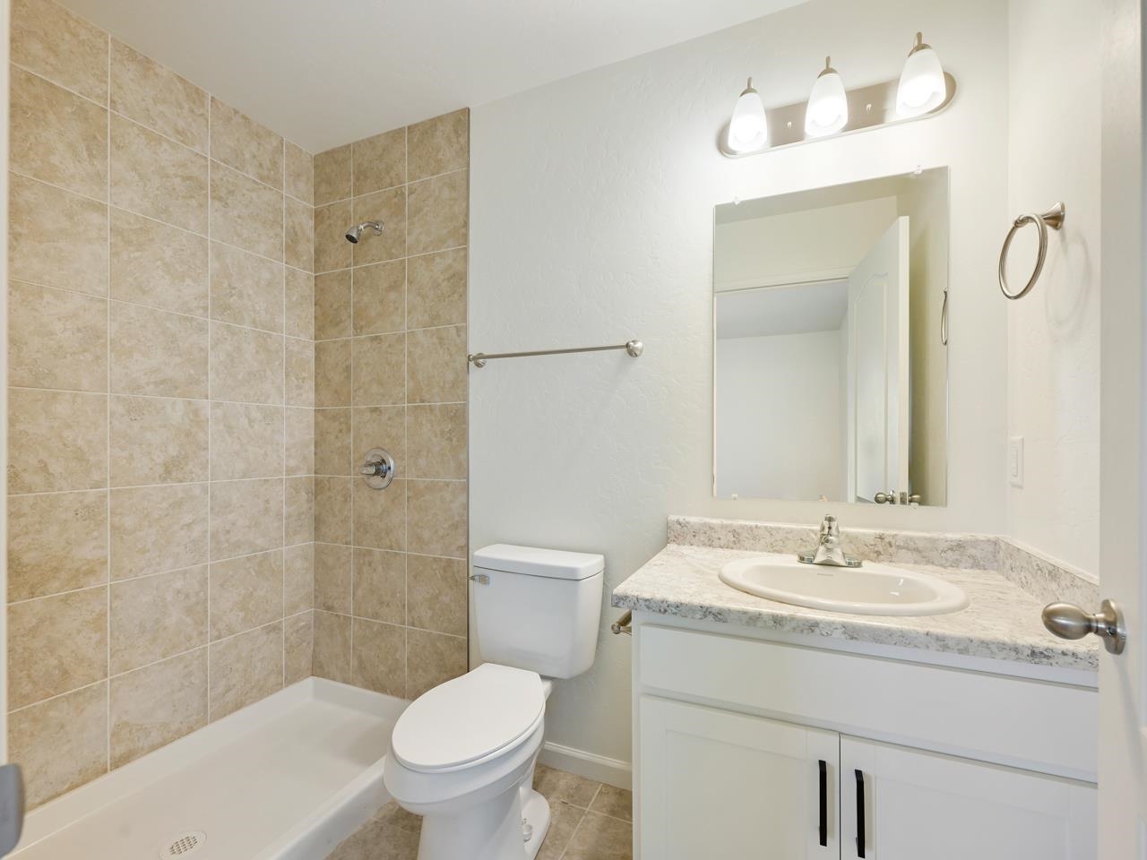 655 Trinity Way, Unit C Grand Junction, CO 81505 - Photo 11 of 20 a bathroom with a granite countertop sink a toilet and shower