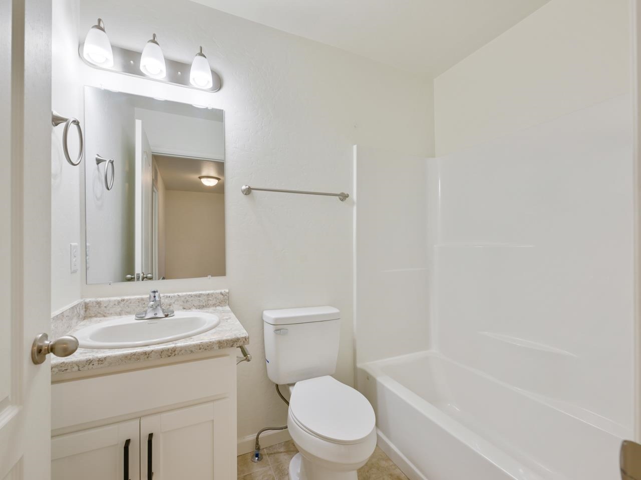 655 Trinity Way, Unit C Grand Junction, CO 81505 - Photo 14 of 20 a bathroom with a granite countertop sink toilet and shower