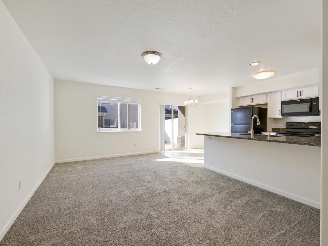 655 Trinity Way, Unit C Grand Junction, CO 81505 - Photo 3 of 20 a view of a kitchen with a sink and a window