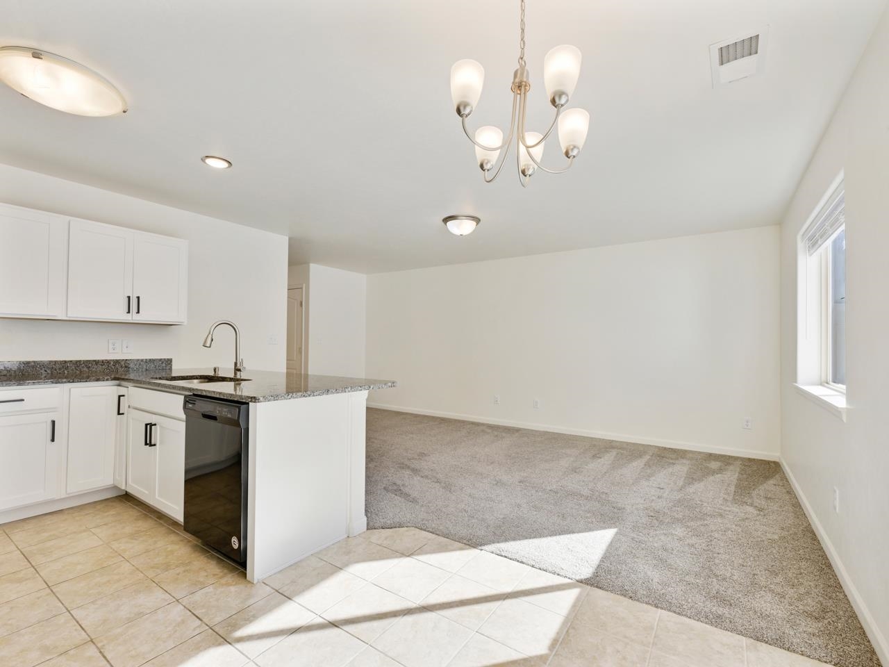 655 Trinity Way, Unit C Grand Junction, CO 81505 - Photo 5 of 20 a kitchen with a sink cabinets and window