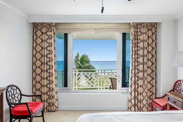 a view of a chairs and table in a balcony