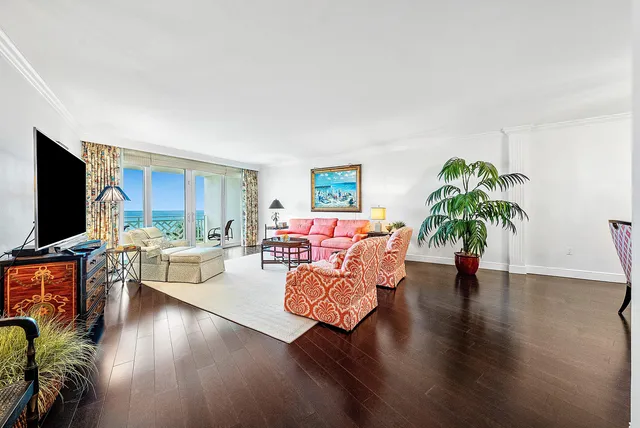 a living room with furniture flat screen tv and wooden floor