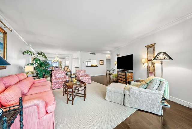a living room with furniture and a chandelier