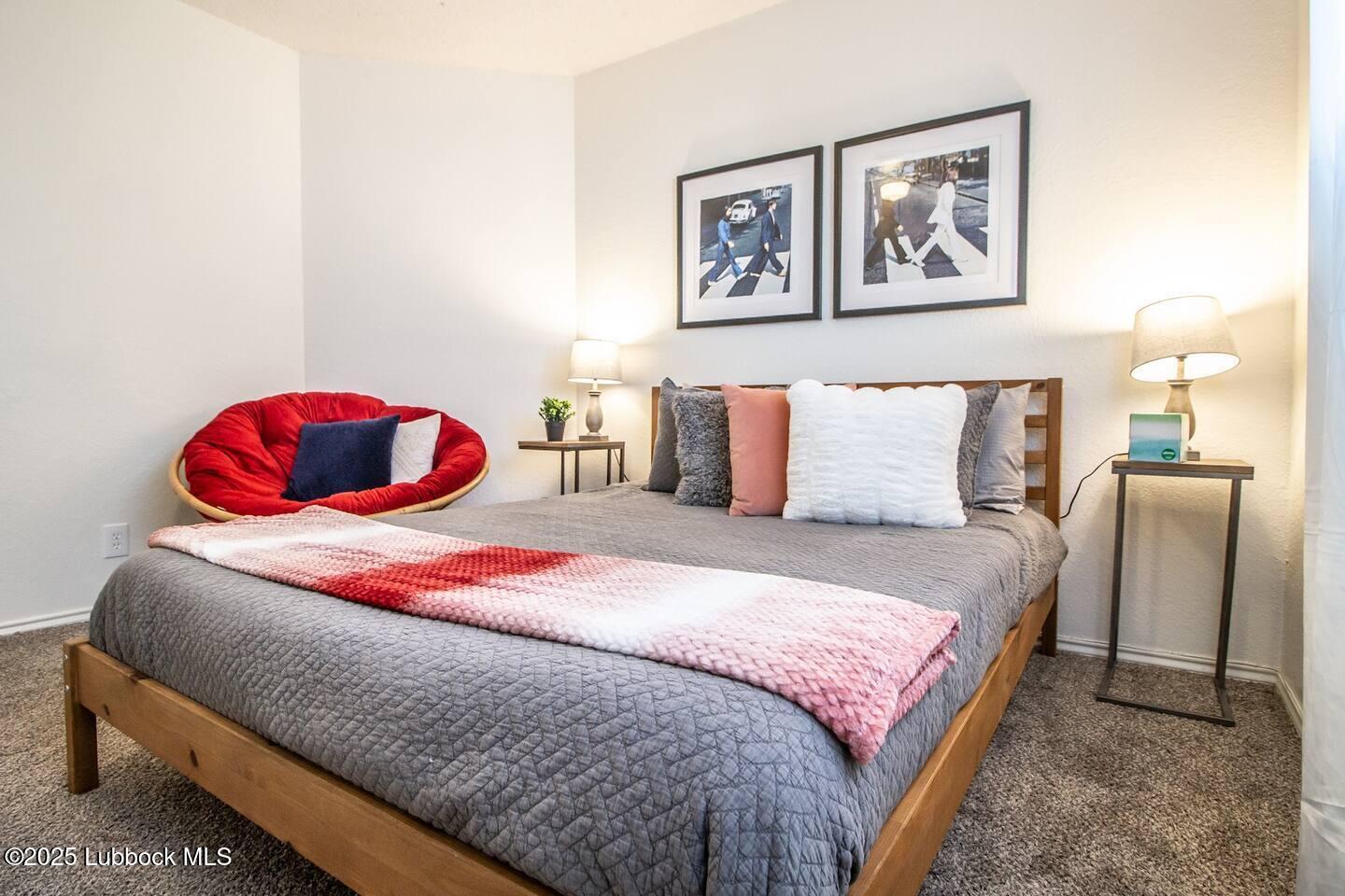 5806 6th Street, Unit B Lubbock, TX 79416 - Photo 11 of 45 a bedroom with a bed and wall painting