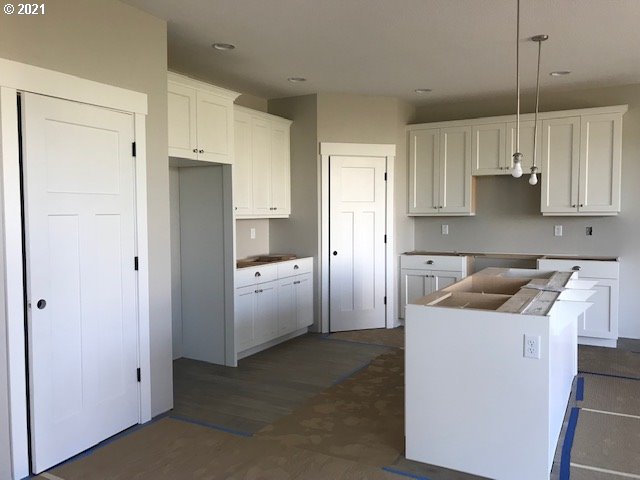 7238 South 11th Street, Unit 55 Ridgefield, WA 98642 - Photo 2 of 2 a kitchen with white cabinets and refrigerator