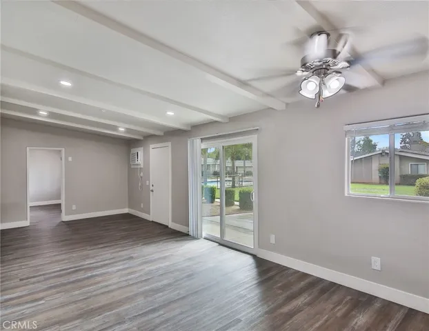 an empty room with windows and a fireplace