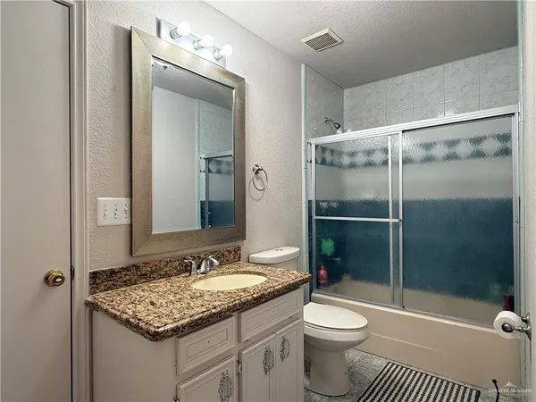 a bedroom with a bed and flat screen tv