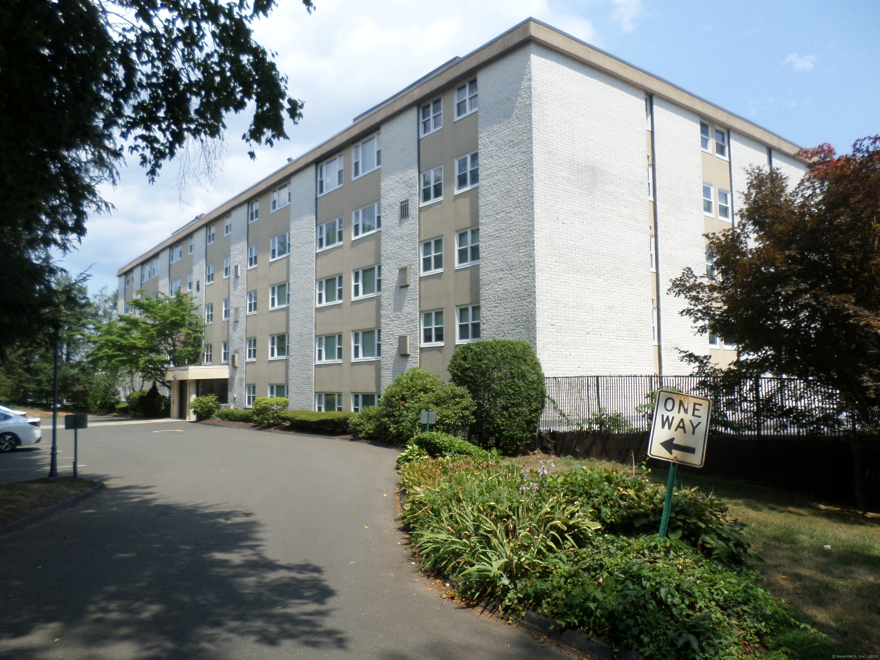 707 East Mix Avenue, Unit 34 Hamden, CT 06514 - Photo 1 of 1 a front view of a building with garden and plants