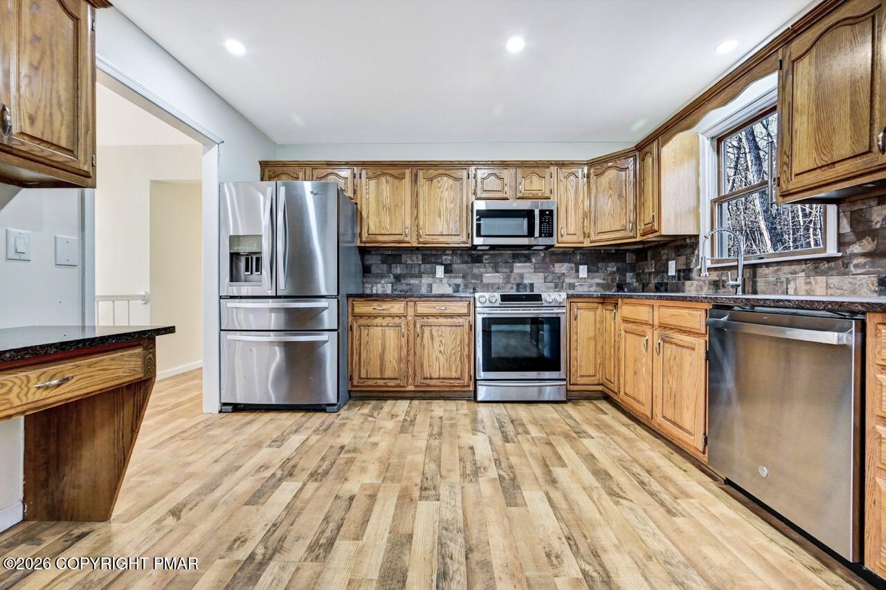 171 Foothill Boulevard Effort, PA 18330 - Photo 18 of 61 a kitchen with stainless steel appliances granite countertop a refrigerator a stove top oven a sink dishwasher and white cabinets with wooden floor