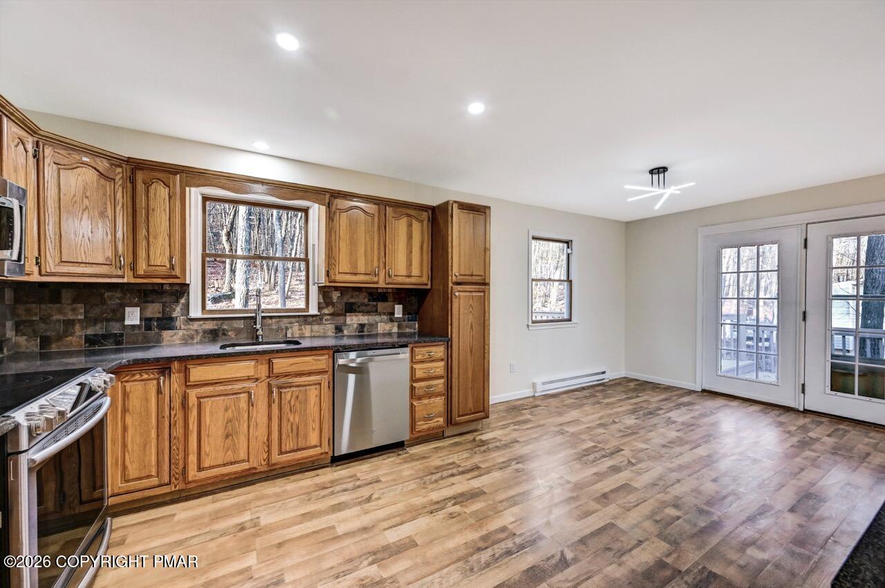 171 Foothill Boulevard Effort, PA 18330 - Photo 20 of 61 a open kitchen with granite countertop a stove top oven a sink and dishwasher with wooden floor
