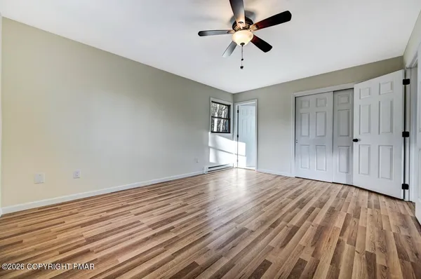 a view of a room with wooden floor and window