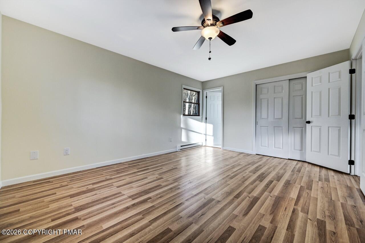 171 Foothill Boulevard Effort, PA 18330 - Photo 27 of 61 an empty room with wooden floor and windows