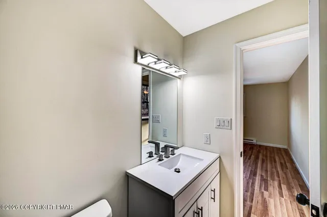 a view of a room with wooden floor and window