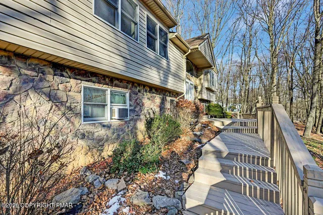 a view of a house with a yard and pathway