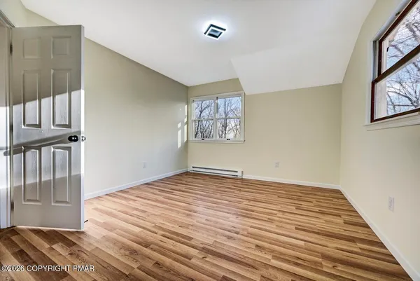 a view of an entryway with wooden floor