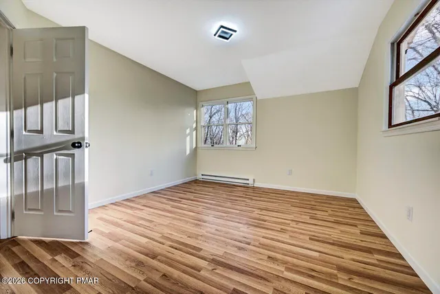 a view of an entryway with wooden floor