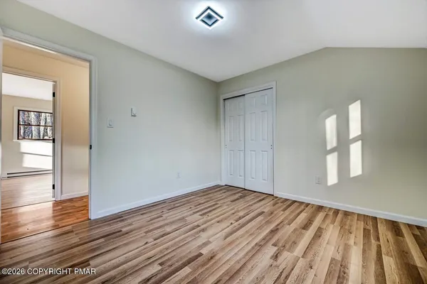 a view of a room with wooden floor and window