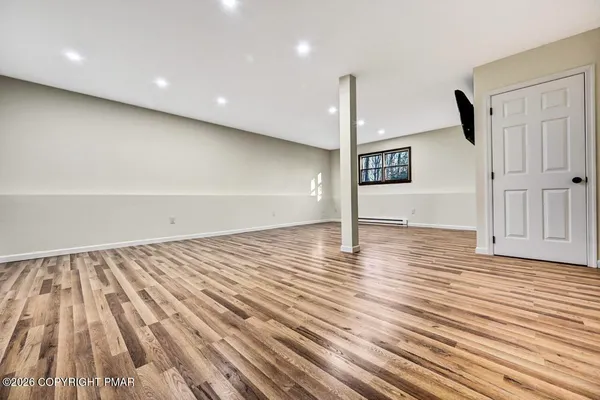 a view of a hallway with wooden floor and entryway