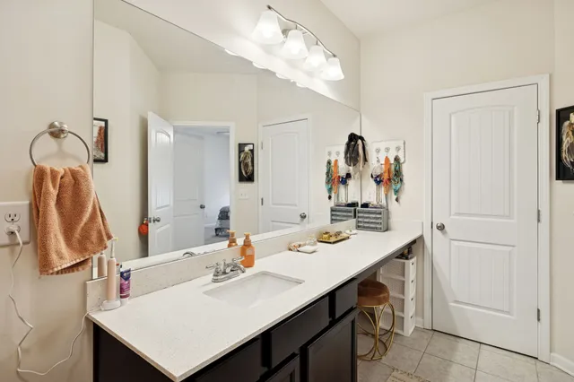 a bathroom with a sink vanity and a mirror