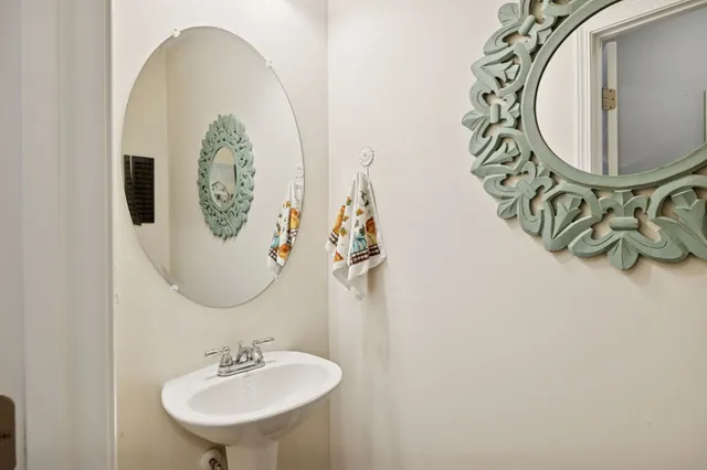 a bathroom with a mirror and a sink