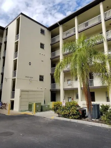 a front view of a building with a garden
