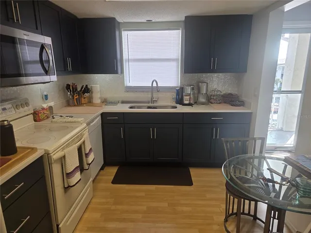 a kitchen with a sink stove and cabinets