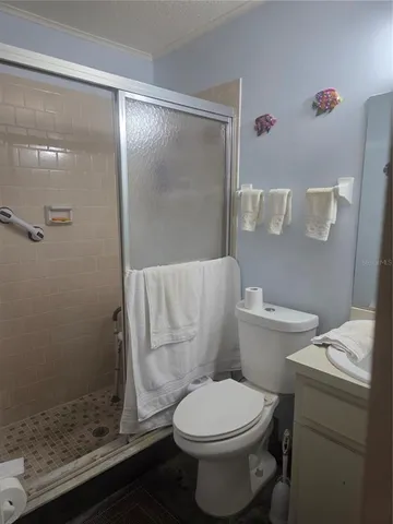 a white toilet sitting next to a shower
