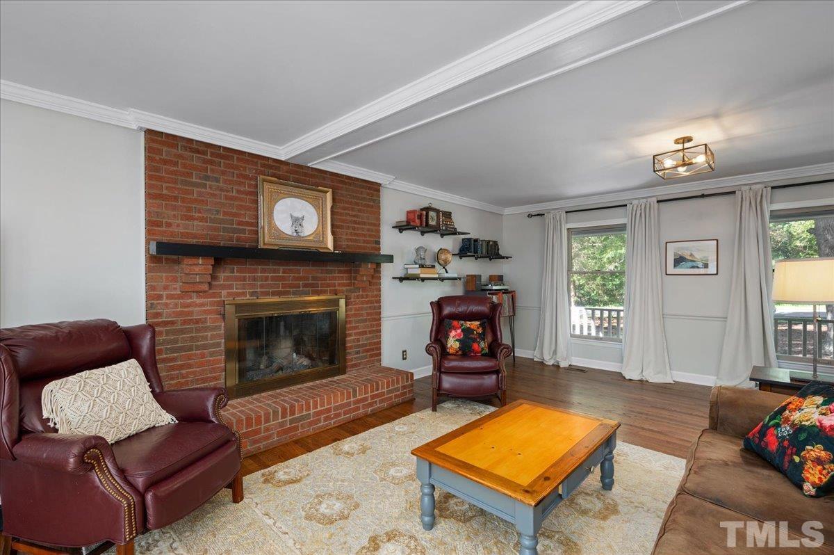 5116 Hallmark Road Durham, NC 27712 - Photo 13 of 31 a living room with furniture a flat screen tv and a fireplace