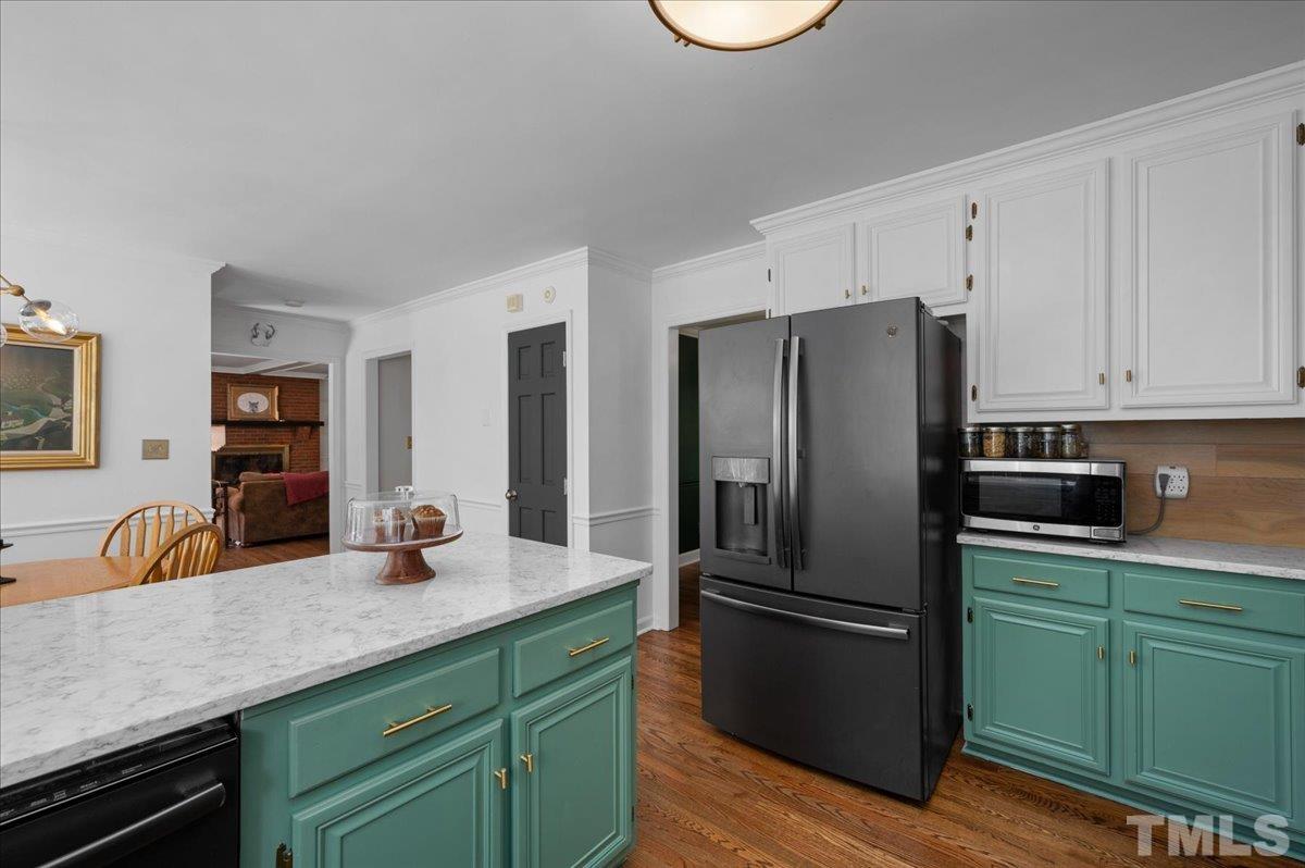 5116 Hallmark Road Durham, NC 27712 - Photo 17 of 31 a kitchen with granite countertop a refrigerator and a sink