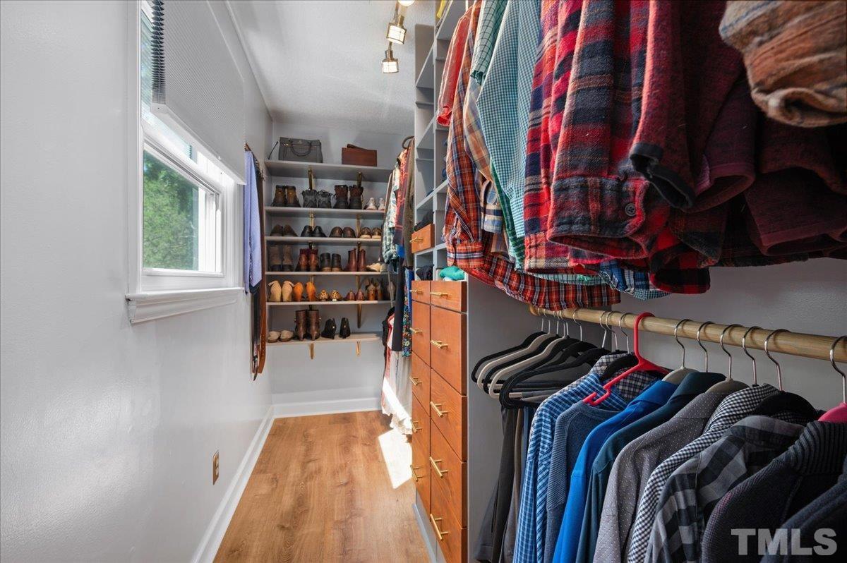 5116 Hallmark Road Durham, NC 27712 - Photo 22 of 31 a view of walk in closet with clothes and shoes