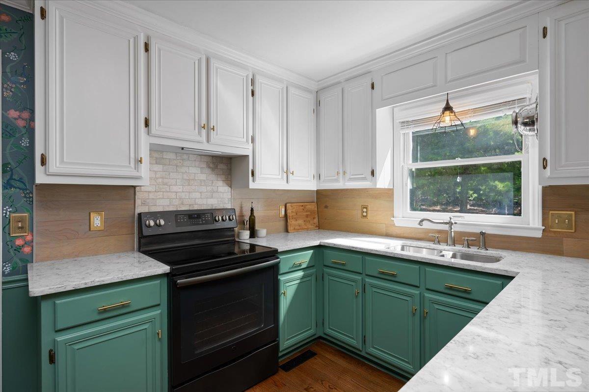5116 Hallmark Road Durham, NC 27712 - Photo 5 of 31 a kitchen with granite countertop white cabinets and a stove