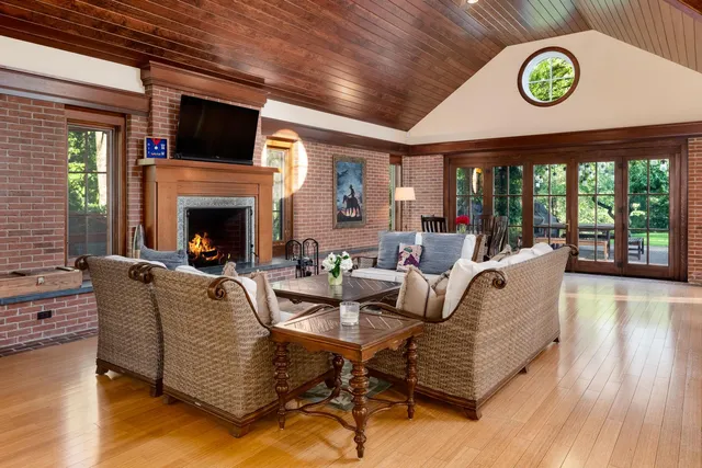 a living room with furniture a flat screen tv and a fireplace