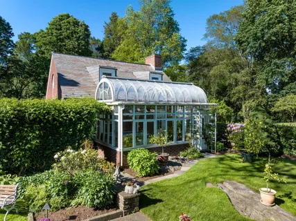 a view of a house with a big yard and potted plants