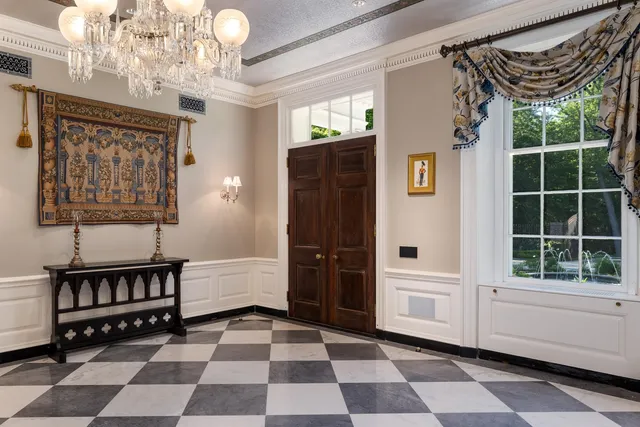 a view of a bedroom with wooden floor and windows