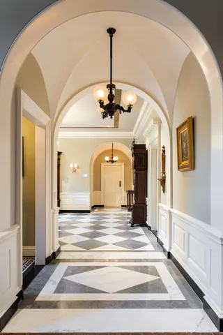 a view of a hallway with a chandelier
