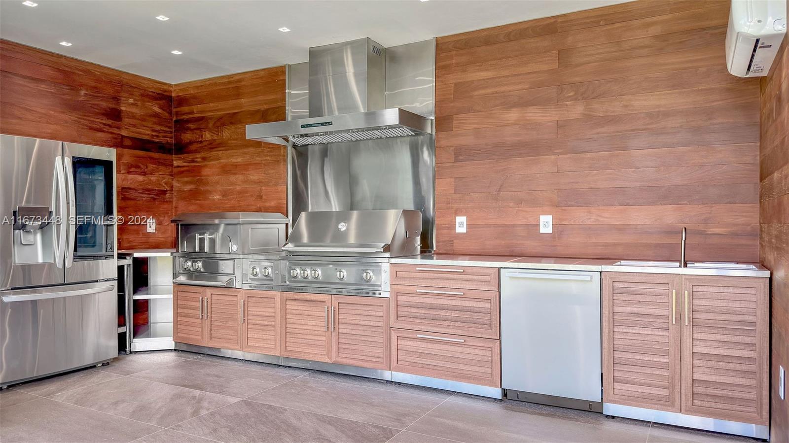9860 Northeast 5th Avenue Road Miami Shores, FL 33138 - Photo 11 of 56 a kitchen with stainless steel appliances kitchen island granite countertop a refrigerator and a stove