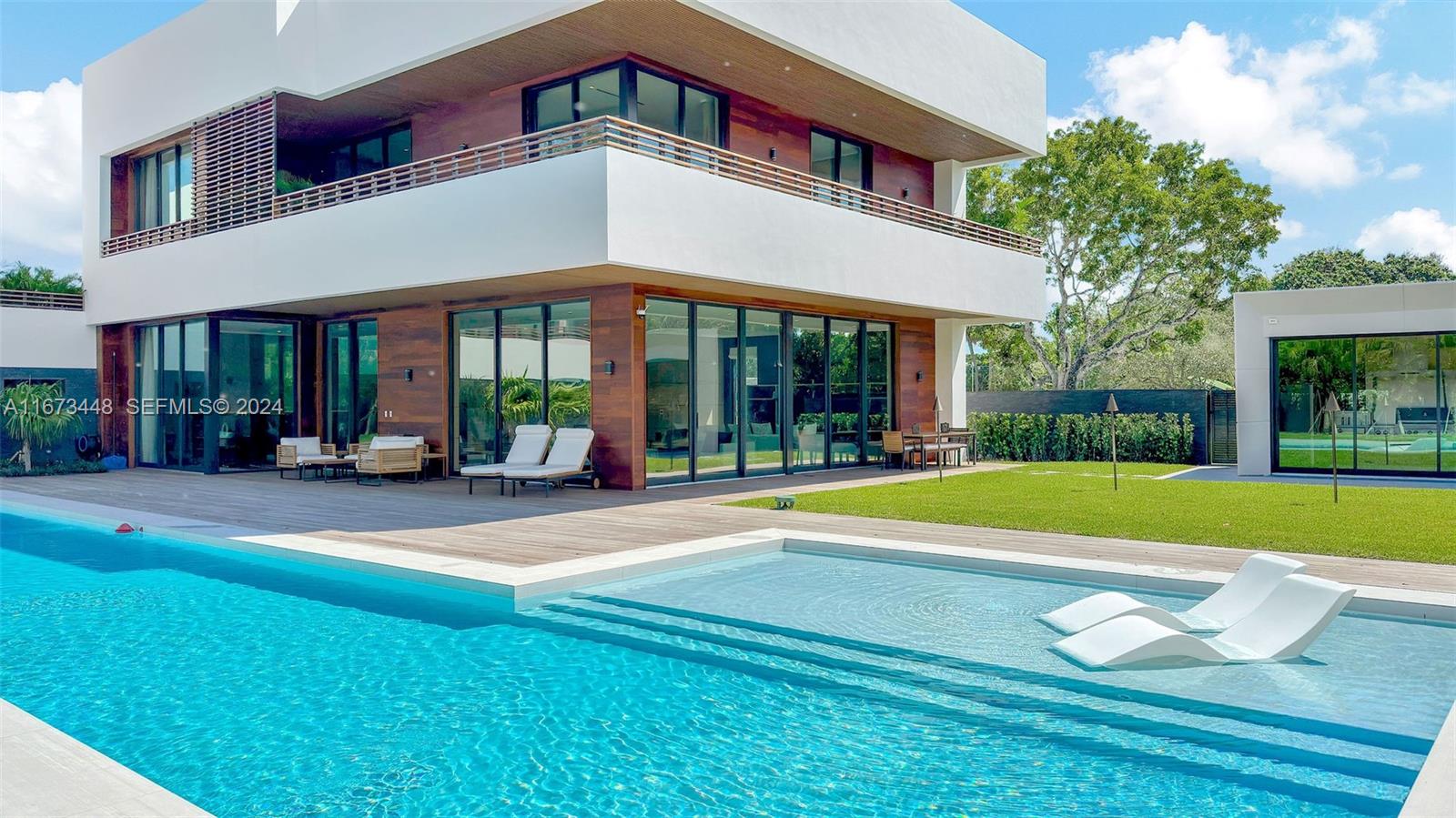 9860 Northeast 5th Avenue Road Miami Shores, FL 33138 - Photo 12 of 56 a view of a building with a swimming pool