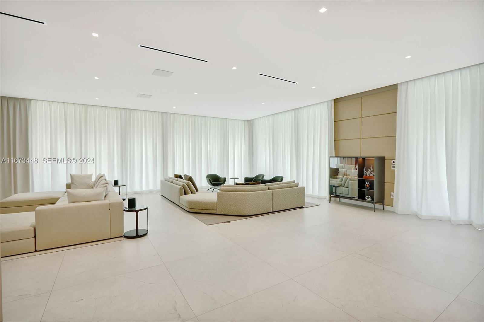 9860 Northeast 5th Avenue Road Miami Shores, FL 33138 - Photo 14 of 56 a living room with furniture and a flat screen tv